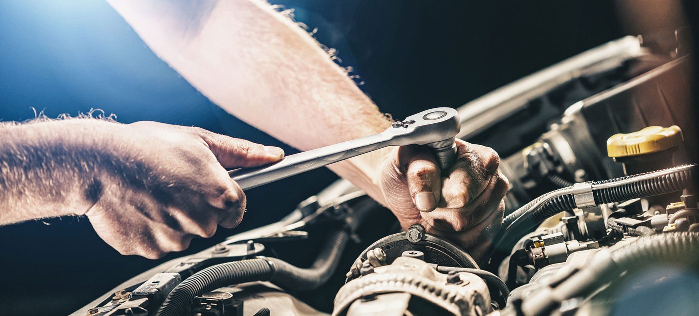 A qualified mechanic servicing a car